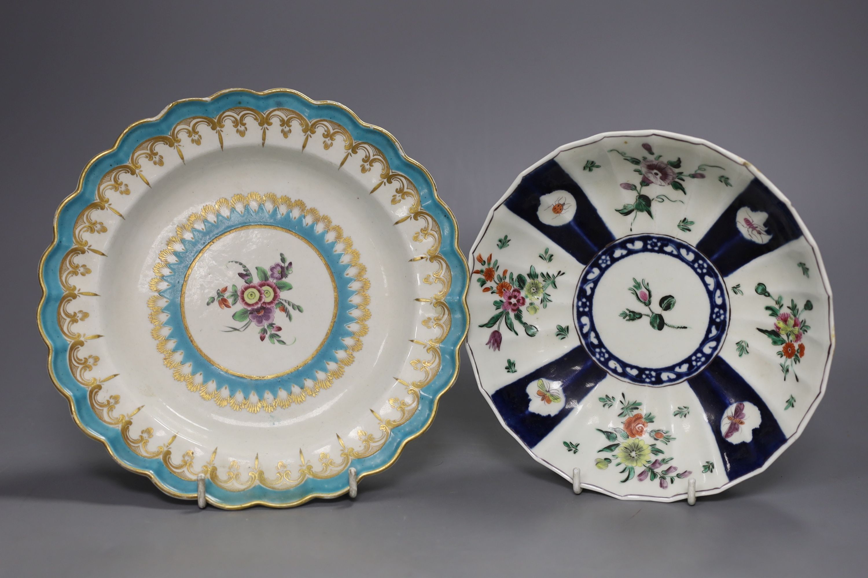 A Worcester plate with two turquoise borders, the centre painted with flowers, a saucer dish with fan shaped panels painted with flowers separated by blue panels and a claret ground plate, turquoise plate 21 cms diameter